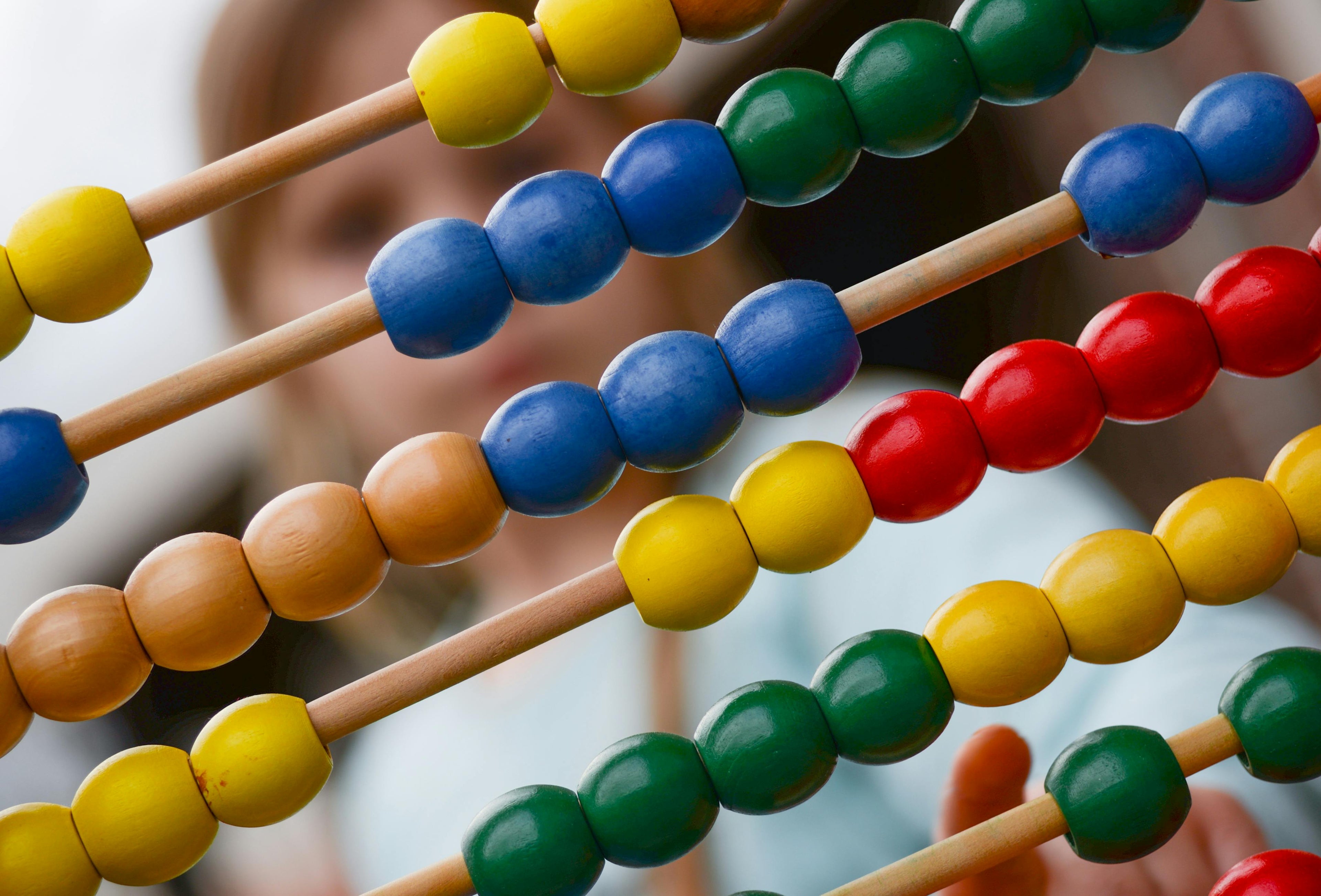 child looking through an abacus